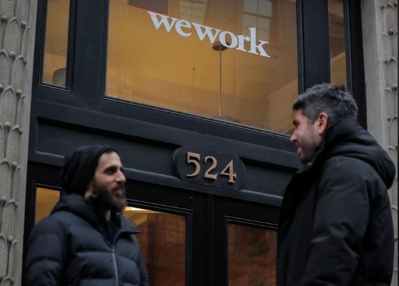 People stand outside a WeWork co-working space in New York City, New York U.S., January 8, 2019. REUTERS/Brendan McDermid
